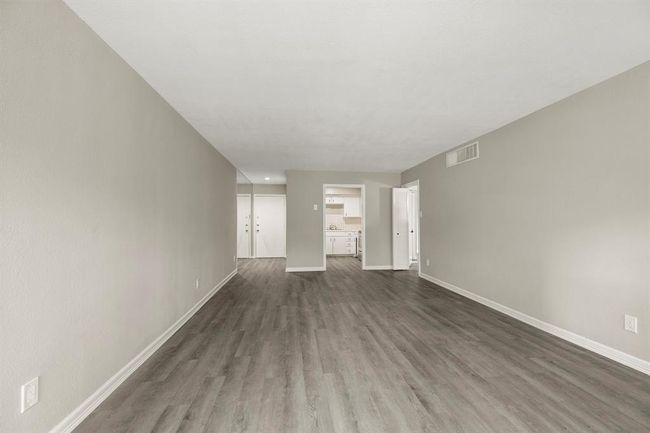 Another view of the living room leading into the kitchen | Image 4