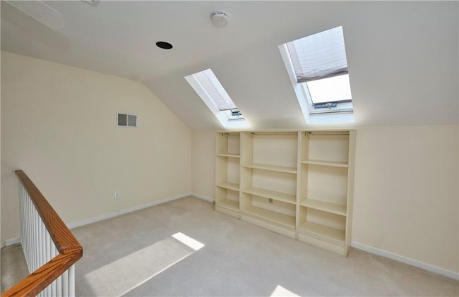 Bonus room featuring lofted ceiling with skylight and light colored carpet | Image 30