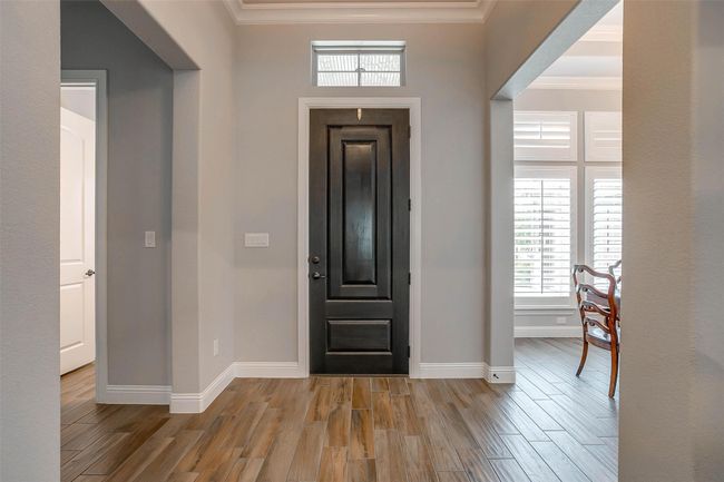 Foyer with crown molding and wood finished floors | Image 4