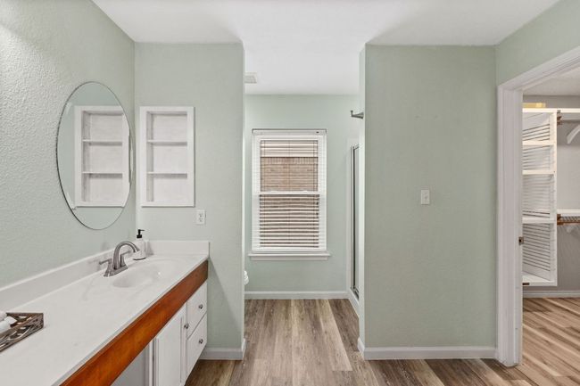 Bathroom featuring vanity, wood finished floors, toilet, and a walk in closet | Image 34