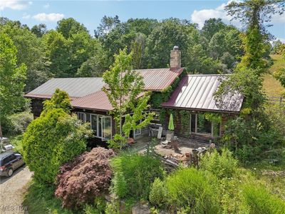 This is an absolutely fabulous and historical two-bedroom, two-bathroom residence with the original log house structure in the middle, flanked by two additions on either side. This truly unique home is peacefully nestled in a most beautiful field and woodland setting and is a must see experience and treat for the eyes. | Image 2