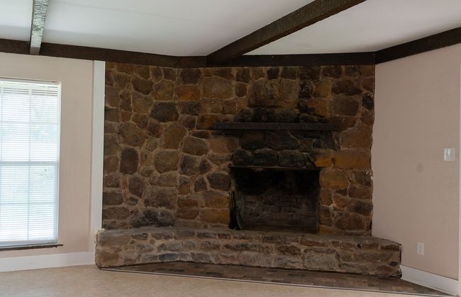 Detailed view of beamed ceiling and baseboards | Image 9