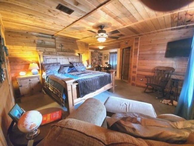 A view of the bedroom toward the office area, with built-in book shelves | Image 17
