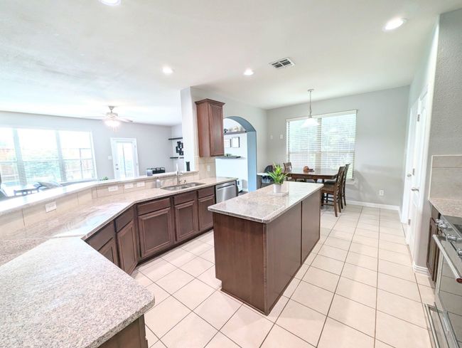 Kitchen with stove, a ceiling fan, arched walkways, healthy amount of natural light, and recessed lighting | Image 22