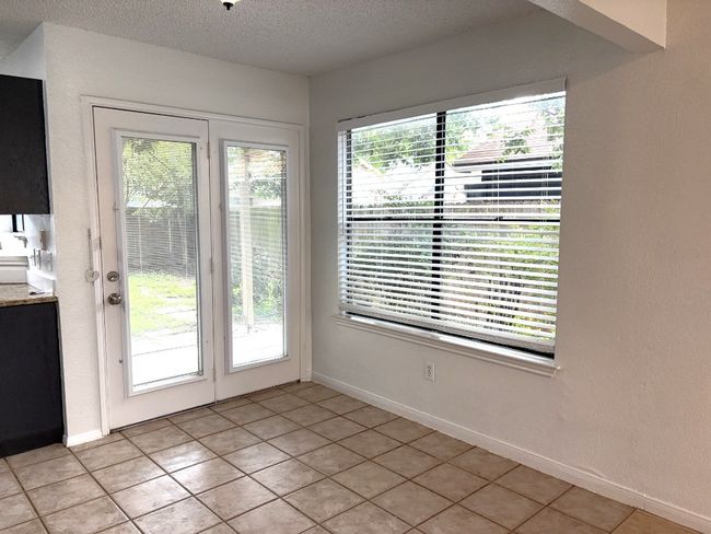 Entryway featuring light tile patterned floors and a textured ceiling | Image 5