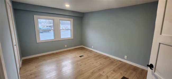 Unfurnished room featuring light wood-style flooring, baseboards, visible vents, and recessed lighting | Image 24