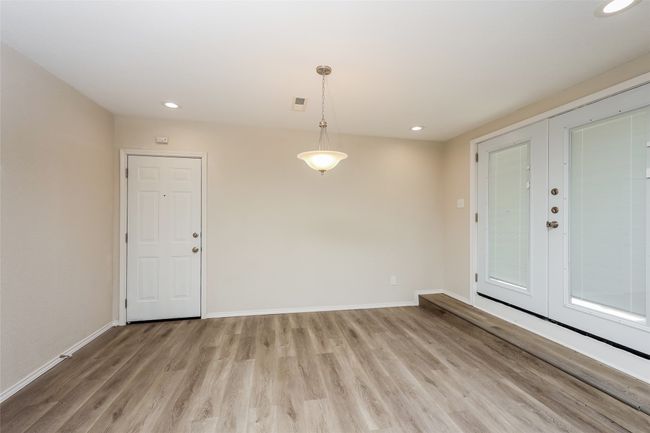 Spare room featuring light wood finished floors, recessed lighting, and french doors | Image 6