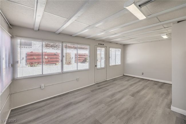 Spare room with wood finished floors and baseboards | Image 19