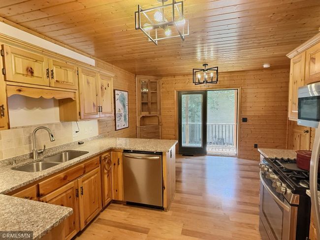 The dining room opens to the main level living room, the door to the left leads to the finished lower level. | Image 9
