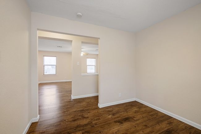 Empty room with dark wood finished floors and baseboards | Image 19