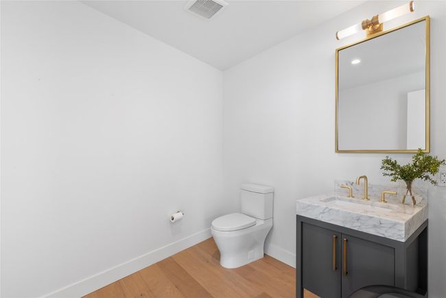 Bathroom with wood finished floors, vanity, toilet, and baseboards | Image 31