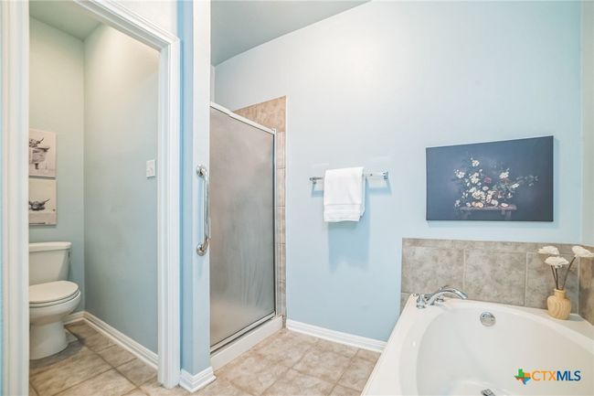 View of tub, shower and water closet. | Image 11