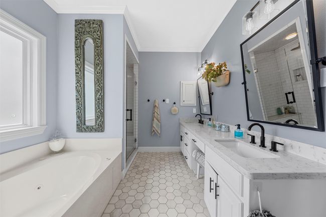 Full bathroom with a stall shower, a garden tub, a sink, and ornamental molding | Image 19
