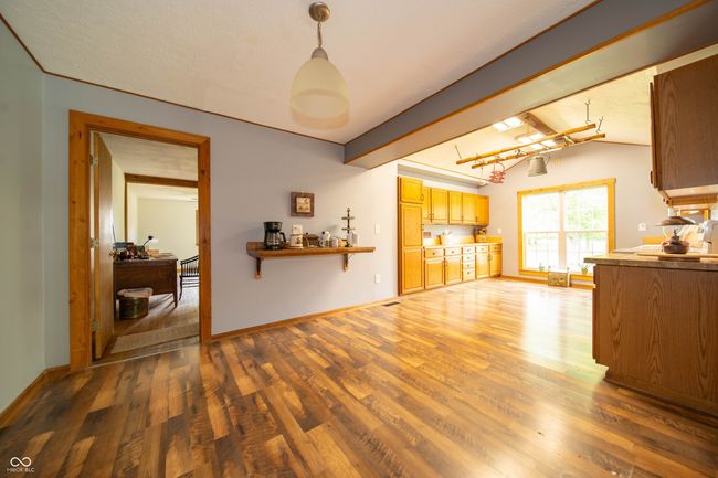 living room with wood finished floors and baseboards | Image 17