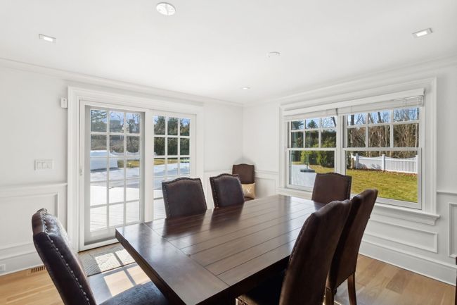 Dining room featuring a wealth of natural light, ornamental molding, and light wood-type flooring | Image 19