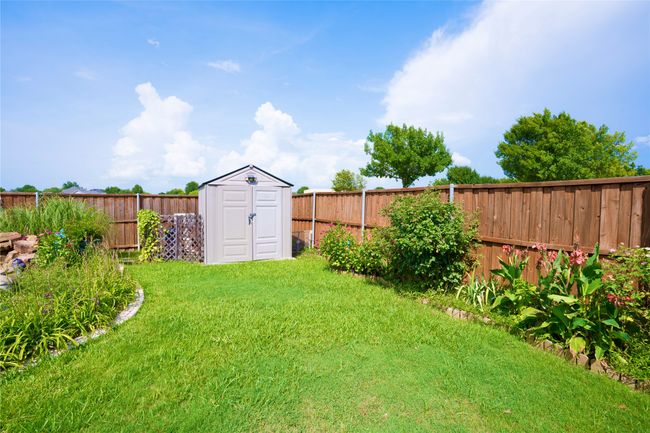 Fenced backyard featuring a shed | Image 24