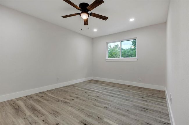 Secondary bedroom #3 with walk in closet, Vinyl flooring, ceiling fan and recess light. | Image 33