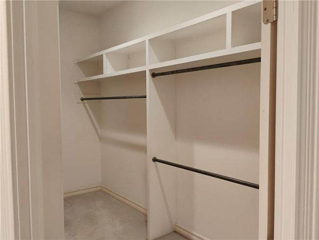 Primary Bedroom Walk in closet #1 with light colored carpet | Image 52