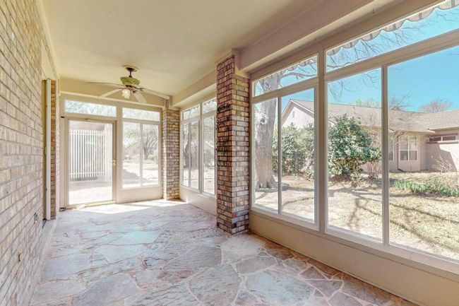 flagstone flooring enhances this 3 season enclosed sunroom | Image 27