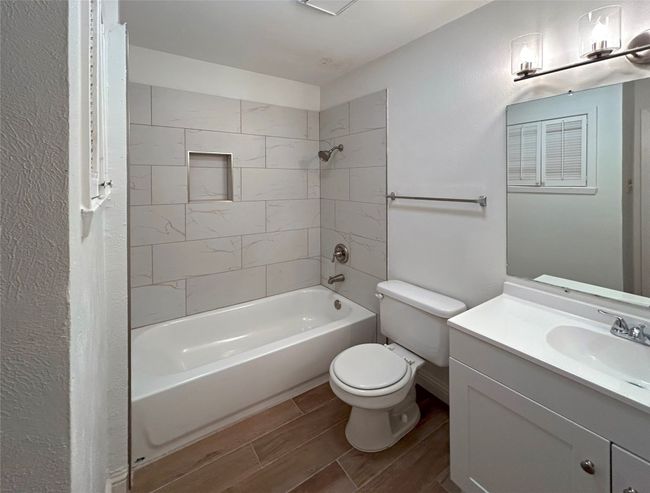 Full bathroom featuring vanity, tiled shower / bath combo, toilet and mini linen closet | Image 26