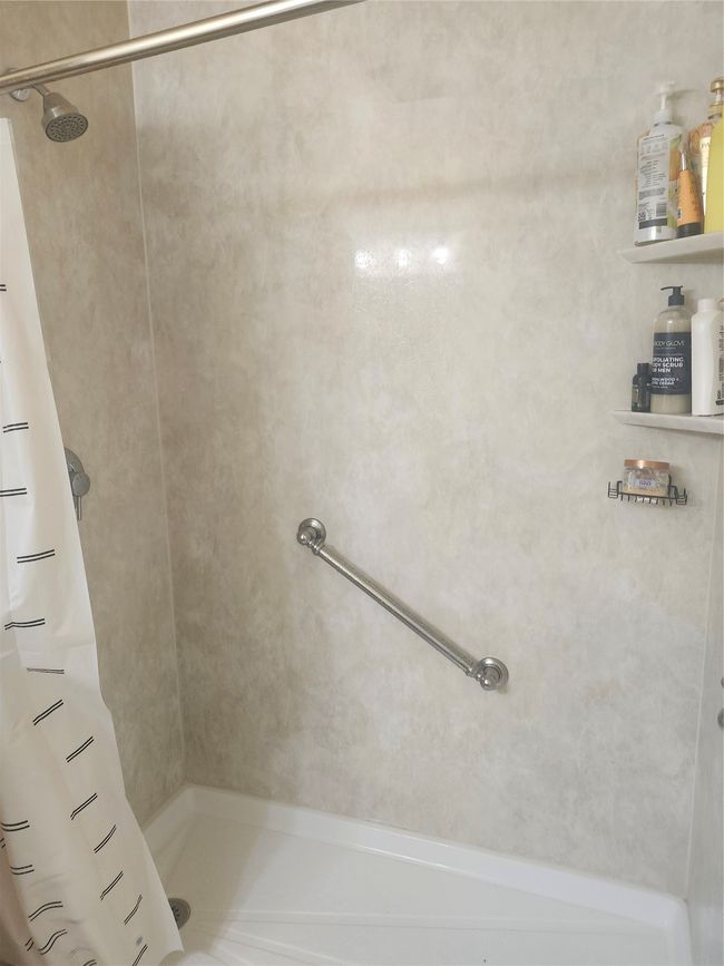 Bathroom featuring curtained shower | Image 11