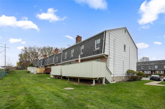 Rear view of property featuring a yard, a chimney, and fence | Image 48