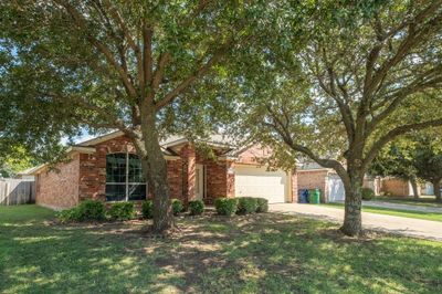 Ranch-style house with a garage and a front lawn | Image 3