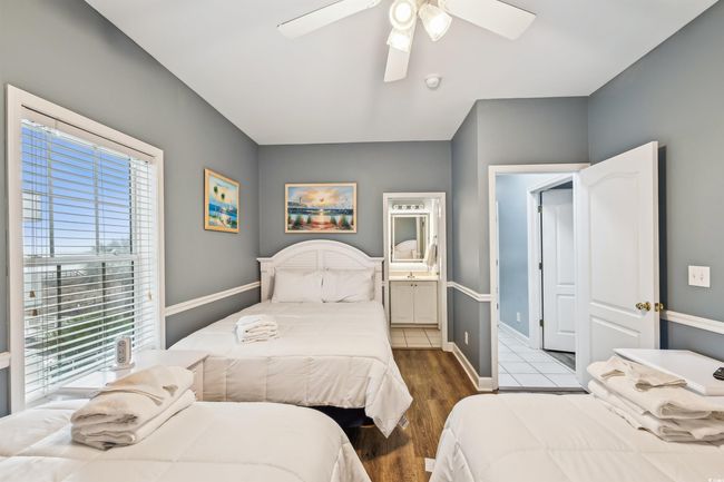 Bedroom featuring wood finished floors, ensuite bath, and ceiling fan | Image 11