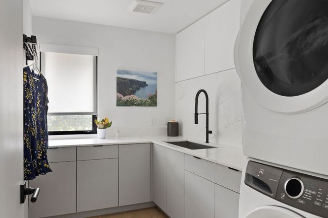 Laundry area with stacked washer / drying machine and cabinet space | Image 24