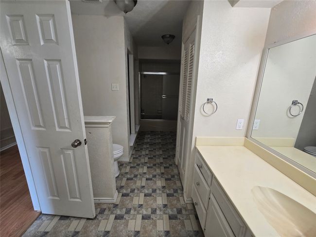 Full bath featuring a shower stall, vanity, and tile patterned floors | Image 13