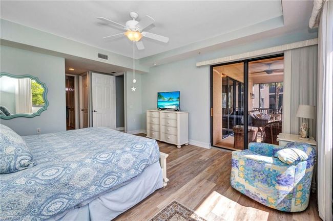 Bedroom featuring access to outside, wood finished floors, and ceiling fan | Image 19