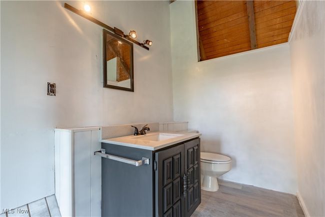 Bathroom with toilet, vanity, and wood finished floors | Image 31