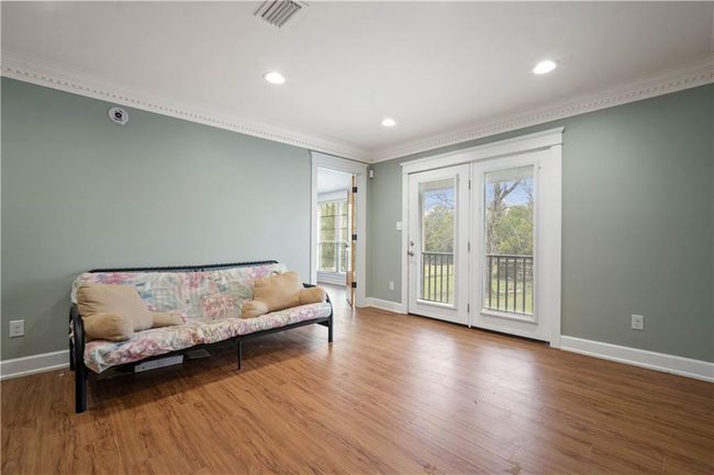 Living area featuring crown molding, recessed lighting, baseboards, visible vents, and wood finished floors | Image 21