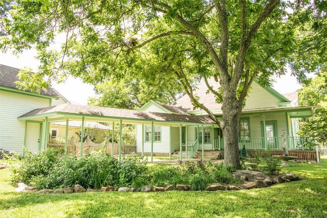 Rear view of house with a yard and covered porch | Image 23