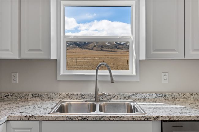 Room details featuring white cabinets, light countertops, and a sink | Image 36