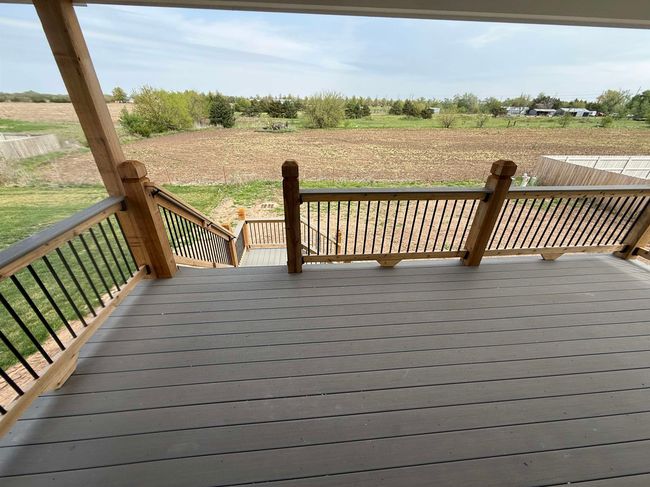 Wooden terrace featuring a view of countryside | Image 5