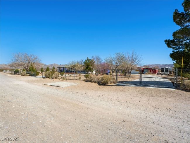 View of road featuring a mountain view, a gated entry, and a gate | Image 56
