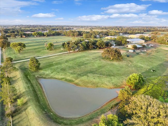 Aerial view of property and surrounding area featuring a nearby body of water | Image 5