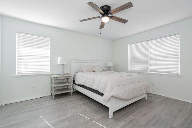 Bedroom featuring wood finished floors and a ceiling fan | Image 19