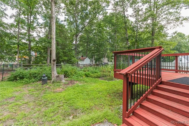 View of yard with a wooden deck and view of scattered trees | Image 38