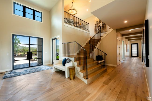 Foyer with stairs, a chandelier, parquet flooring, recessed lighting, and a high ceiling | Image 8
