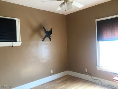 Spare room with light wood-type flooring and ceiling fan | Image 3