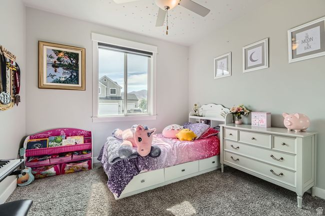 Bedroom featuring dark colored carpet and ceiling fan | Image 16