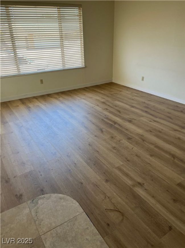 Empty room featuring wood finished floors and baseboards | Image 8