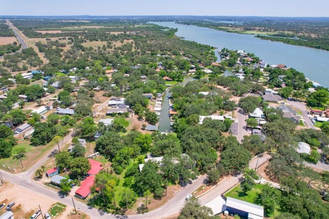 Aerial view of residential area with a large body of water | Image 6