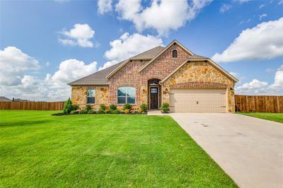 View of front of property with a garage and a front lawn | Image 1