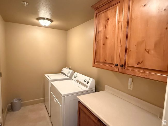 Washroom with cabinet space, washing machine and clothes dryer, and baseboards | Image 18