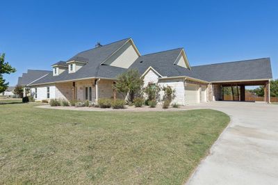 View of front of house featuring a front yard, a garage, and a carport | Image 3