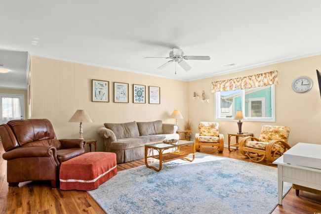 Living room featuring ceiling fan, wood-type flooring, and ornamental molding | Image 8