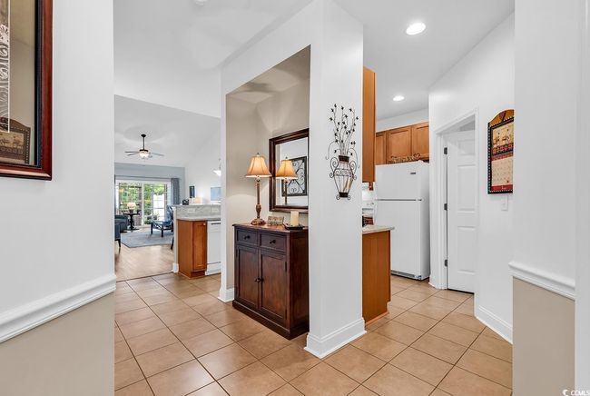 Kitchen featuring white appliances, light tile patterned flooring, ceiling fan, recessed lighting, and light countertops | Image 4